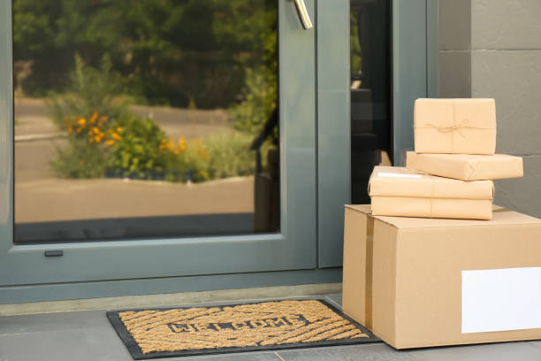 istock Cardboard boxes near door. Parcel delivery service 1349121547
