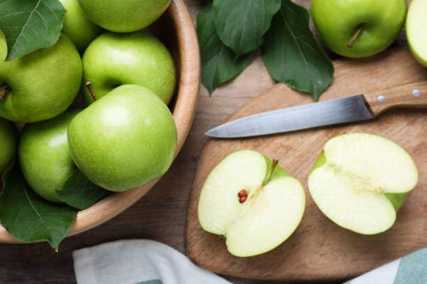 istock Flat lay composition with juicy green apples on wooden table 1349122265