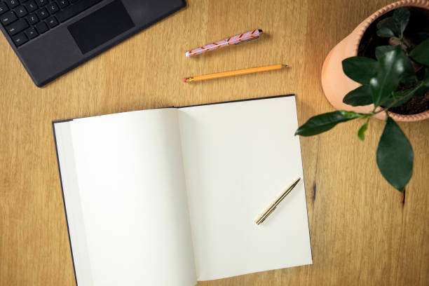 istock Office desk table with computer, supplies, green stylish plant and blank note book Top view with copy space 1349122780