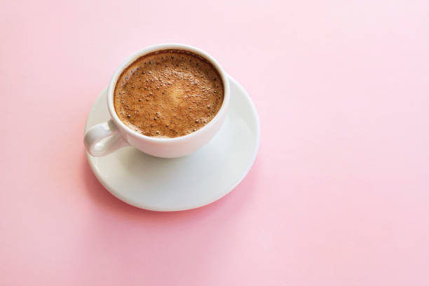 istock A cup of fresh coffee on pink background 1349123868