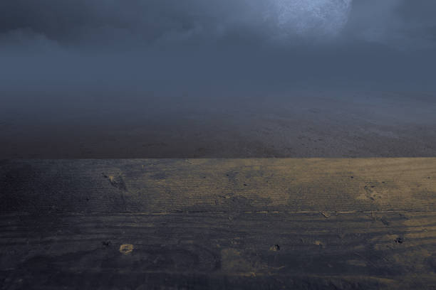 istock Wooden table with a full moon with dark cloudscapes on the night 1349124914