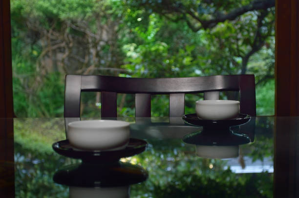 istock Cups of Green Tea on the Table surrounded by Trees 1349126129