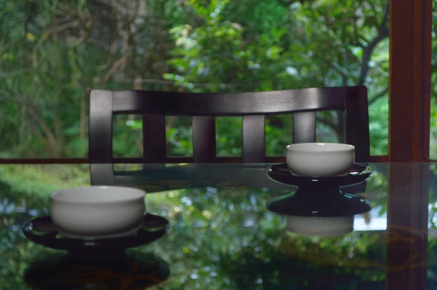 istock Cups of Green Tea on the Table surrounded by Trees 1349126131