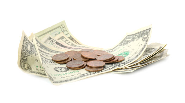 istock Dollar bills and coins isolated on white 1349126314