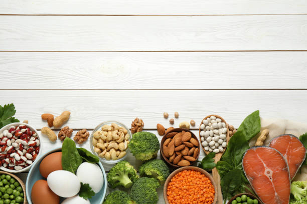 istock Products rich in protein on white wooden table, flat lay. Space for text 1349126479