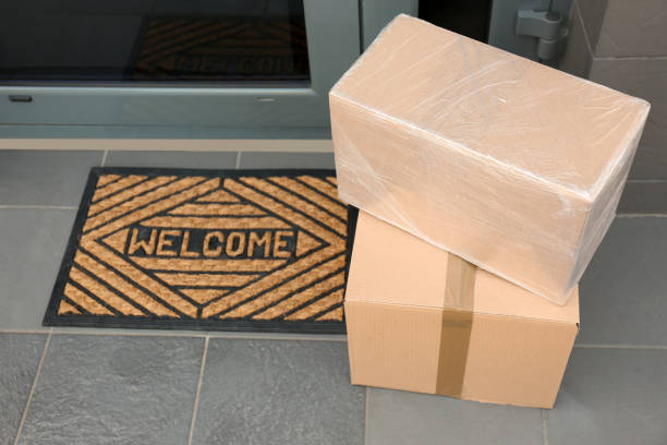 istock Cardboard boxes near door. Parcel delivery service 1349126525