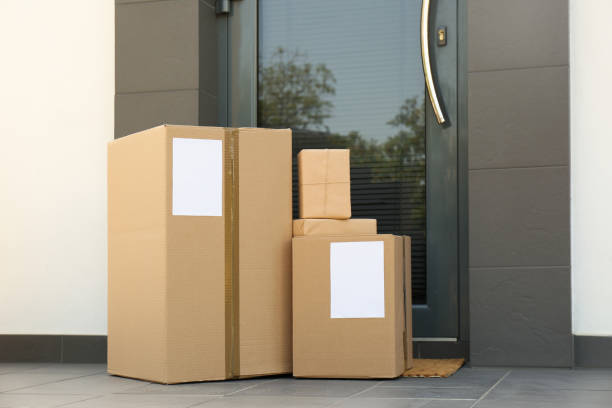 istock Cardboard boxes near door. Parcel delivery service 1349126684