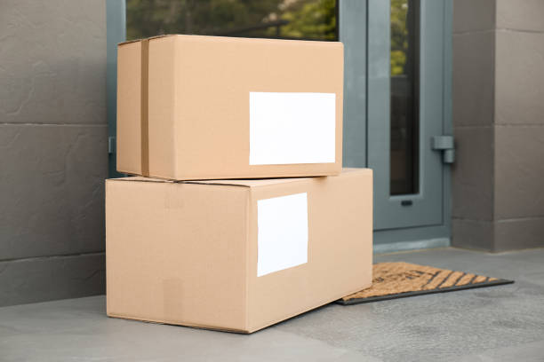 istock Cardboard boxes near door. Parcel delivery service 1349126766