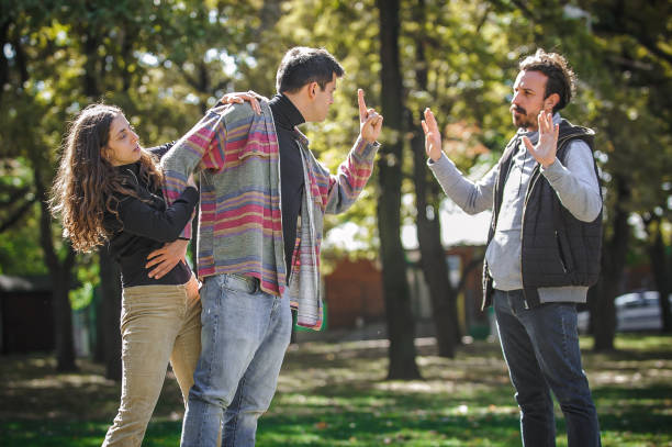 istock Two aggressive men in quarrel and woman. Finger pointing 1349127982