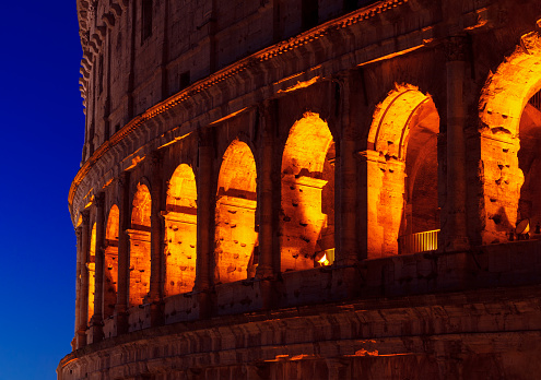 Illuminated arches of Colosseum . Ancient architecture in Rome Italy