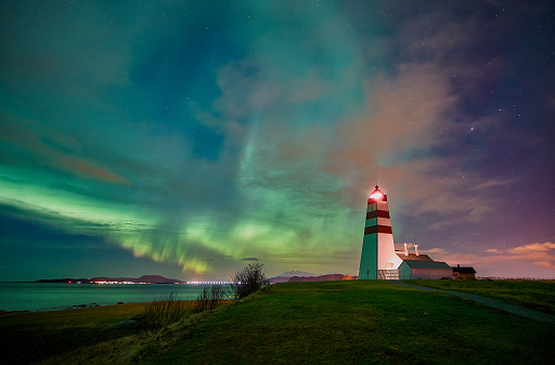 Northern lights dancing and lighting up the lighthouse