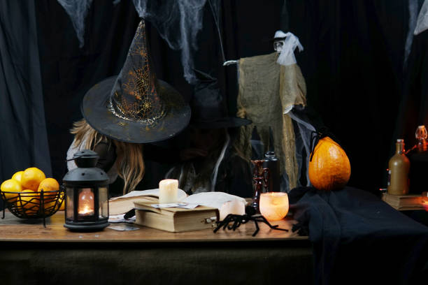istock two witch girls conjuring on halloween 1349136731