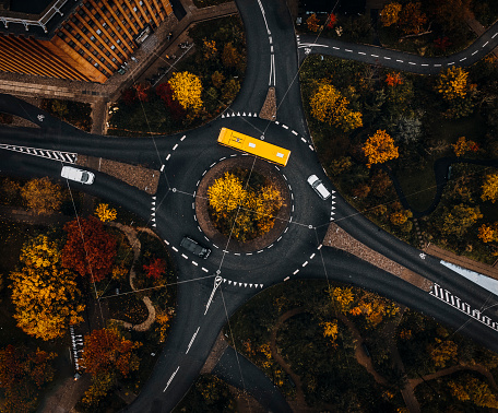 Drone images of city bus driving through a roundabout in 