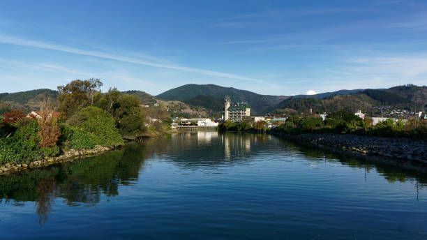 Panorama of Nelson City, reflected in the still waters of the Maitai River, New Zealand. Panorama of Nelson City, reflected in the still waters of the Maitai River, New Zealand. nelson city new zealand stock pictures, royalty-free photos & images