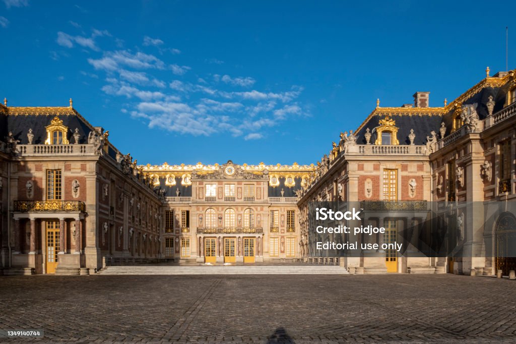 Versailles palace outside Paris at sunrise, France Exterior of the Palace of Versailles before the crowds arrive. Chateau de Versailles Stock Photo