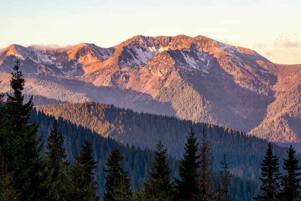 istock Beautiful rocky mountain range illuminated by morning sun 1349140856