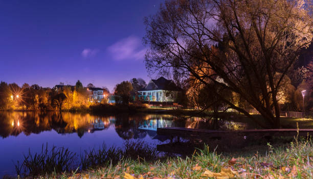 Moscow. October 15, 2021. Golden autumn in Meshchersky Park at night, illuminated by moonlight and street lamps.