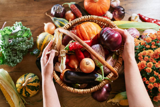 istock Harvesting season concept: putting vegetables in basket 1349142341