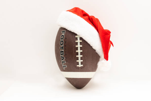 istock Santa hat with rugby ball on white background 1349142391