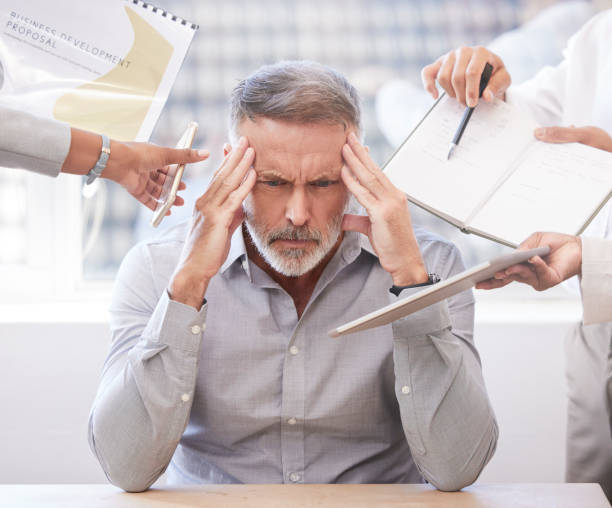 istock Cropped shot of a handsome mature businessman looking stressed while being presented with multiple tasks at his desk in the office 1349143379