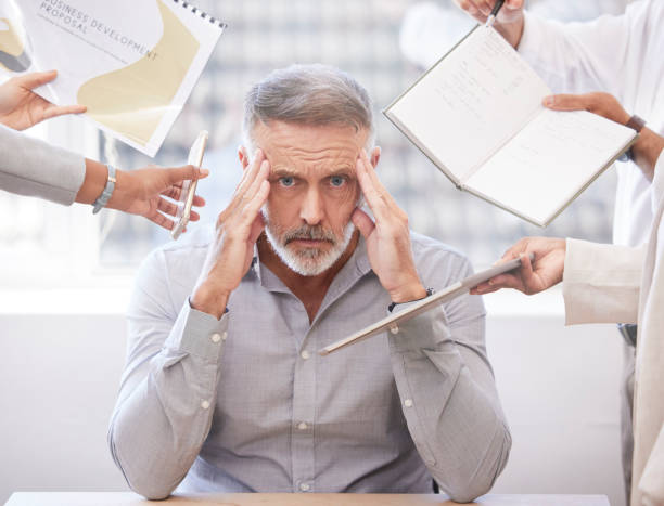 istock Cropped portrait of a handsome mature businessman looking stressed while being presented with multiple tasks at his desk in the office 1349143380