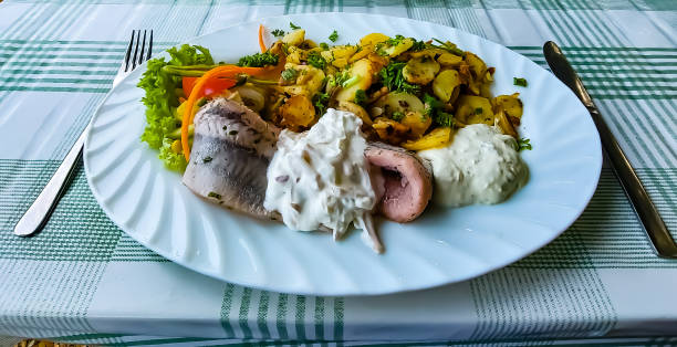 Fried potatoes, herring remoulade and salad