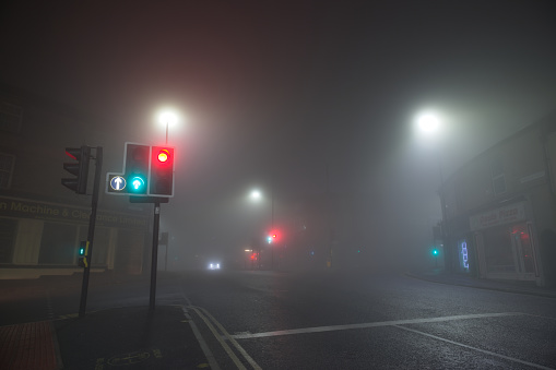 Sheffield, United Kingdom, 8th November, 2020: Very heavy fog at a crossroads in broomhill. Looking along fulwood road, traffic light in foreground.