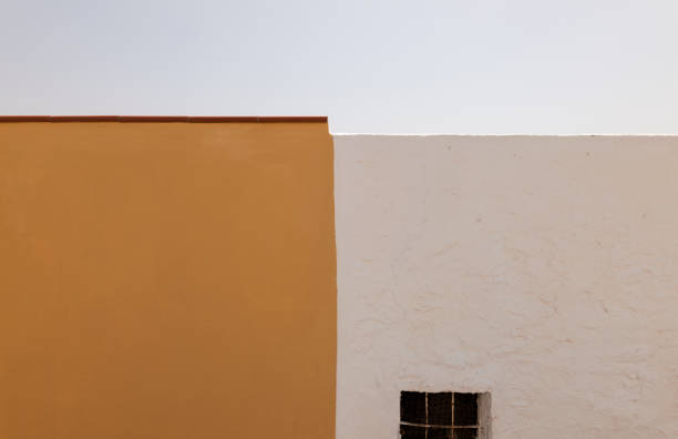 Yellow and white wall against clear sky
