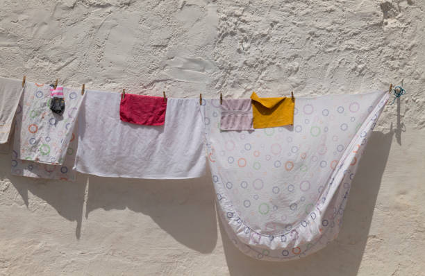 Daily laundry against white wall in summer