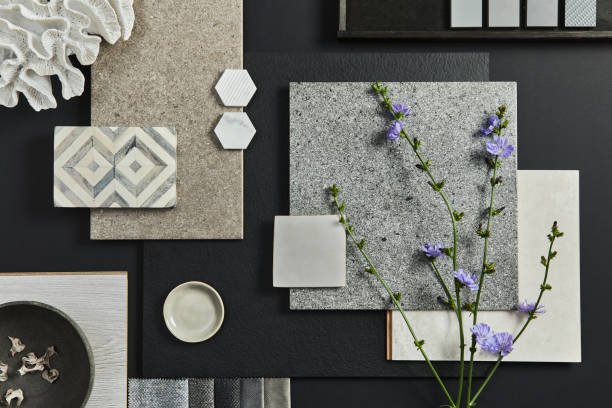 Flat lay composition of creative black architect moodboard with samples of building, textile and natural materials and personal accessories. Top view, black backgroung, template.