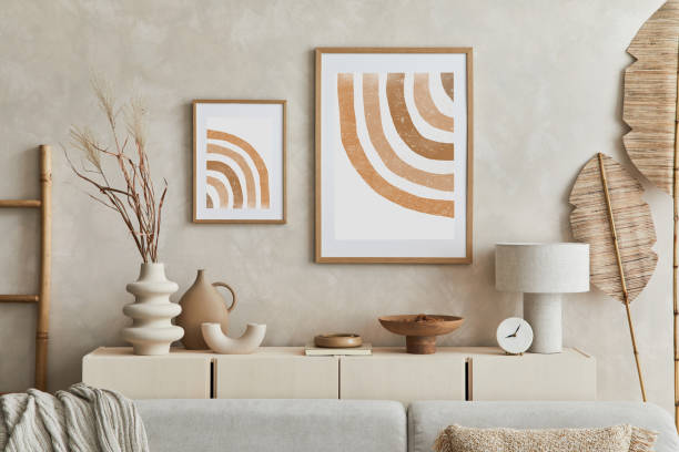 istock Creative composition of stylish living room interior with mock up poster frame, sofa, commode clay vases and stylish personal accessories. Pastel neutral colours. Template.