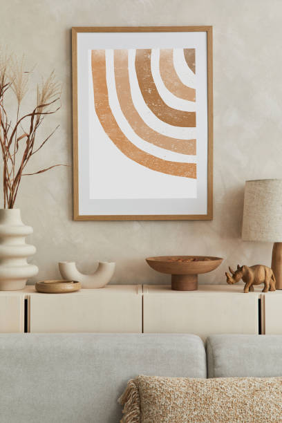 istock Creative composition of stylish living room interior with mock up poster frame, sofa, commode clay vases and stylish personal accessories. Pastel neutral colours. Template.