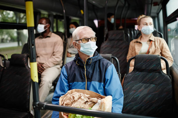 istock Senior Man Wearing Mask on Bus 1349155566