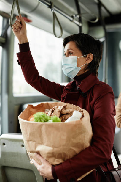 istock Woman Wearing Mask on Bus Side View 1349155574