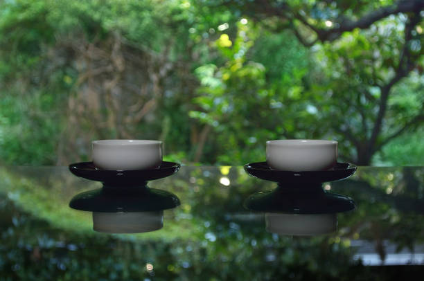 istock Cups of Green Tea on the Table surrounded by Trees 1349155883