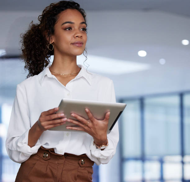 istock Shot of a young businesswoman using a digital tablet at work 1349156021
