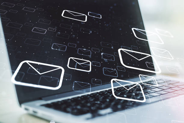 istock Double exposure of postal envelopes hologram on laptop background. Electronic mail and spam concept 1349157384