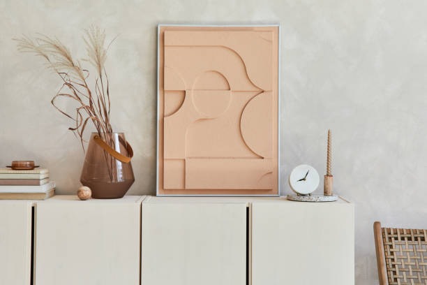 istock Creative composition of modern beige living room interior design with mock up structure painting, beige wooden sideboard and boho inspired personal accessories. Template. 1349157461