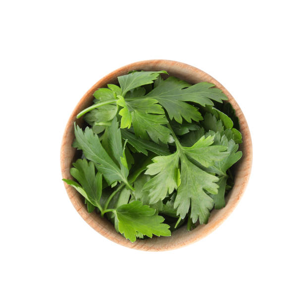 istock Fresh green parsley in bowl isolated on white, top view 1349157810