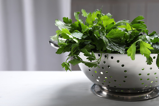 Fresh green parsley on table, closeup. Space for text