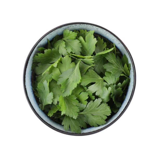 istock Fresh green parsley in bowl isolated on white, top view 1349157959