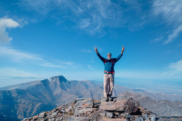 Elderly climber is happy and proud of herself after a hard climbing activity.