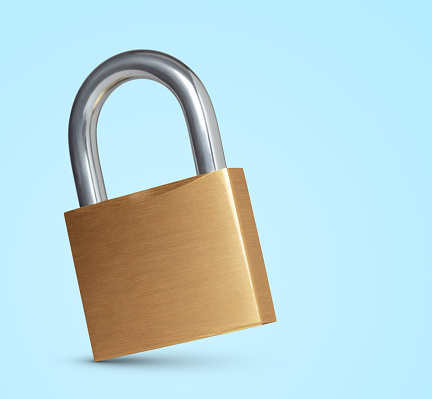 Gold padlock on blue background. This file is cleaned, retouched and contains clipping path.