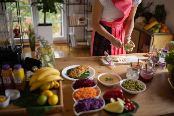 istock Woman peeling apple while preparing smoothie at home 1349161132