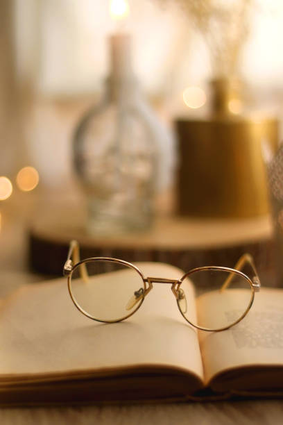 istock Book, Reading Glasses and Candles 1349162730