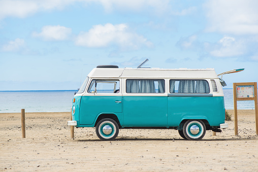 Fuerteventura, Canary Islands - June 23 2018. Classic Green and white Camper VW Van parked on beach in Fuertev