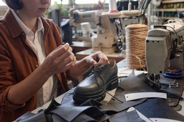 istock Woman making new shoes in the workshop 1349164103