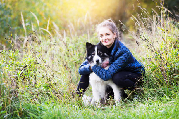 istock Cute girl sits and hugs her dog 1349164448