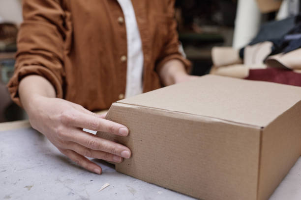 istock Delivery person packing box 1349165052
