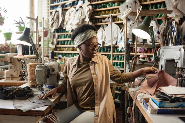 istock Tailor woman working in sewing factory 1349165132